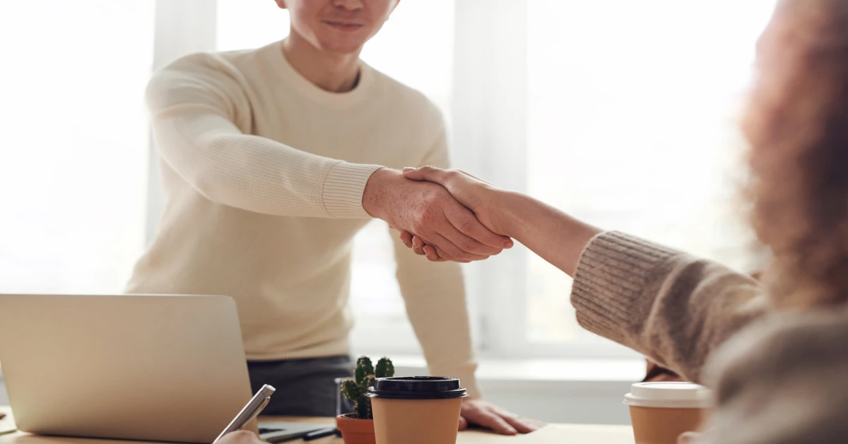 Amazon seller consultant shaking hands with a happy client